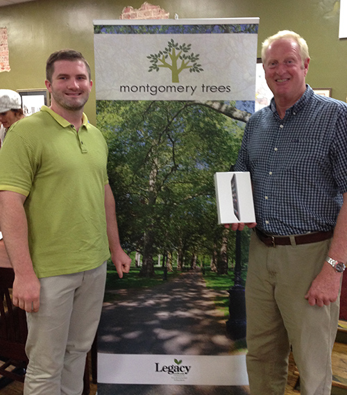 Montgomery Trees President, Chase Fisher with Darrell Mann, winner of the new member iPad mini raffle.